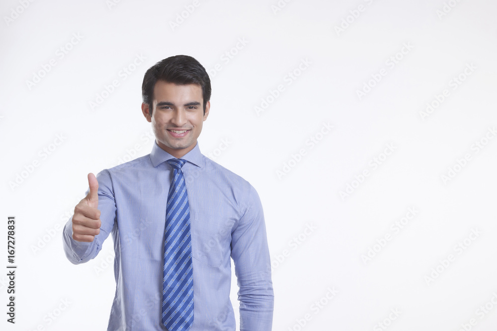 Portrait of a male executive giving thumbs up Portrait of a male executive giving thumbs up