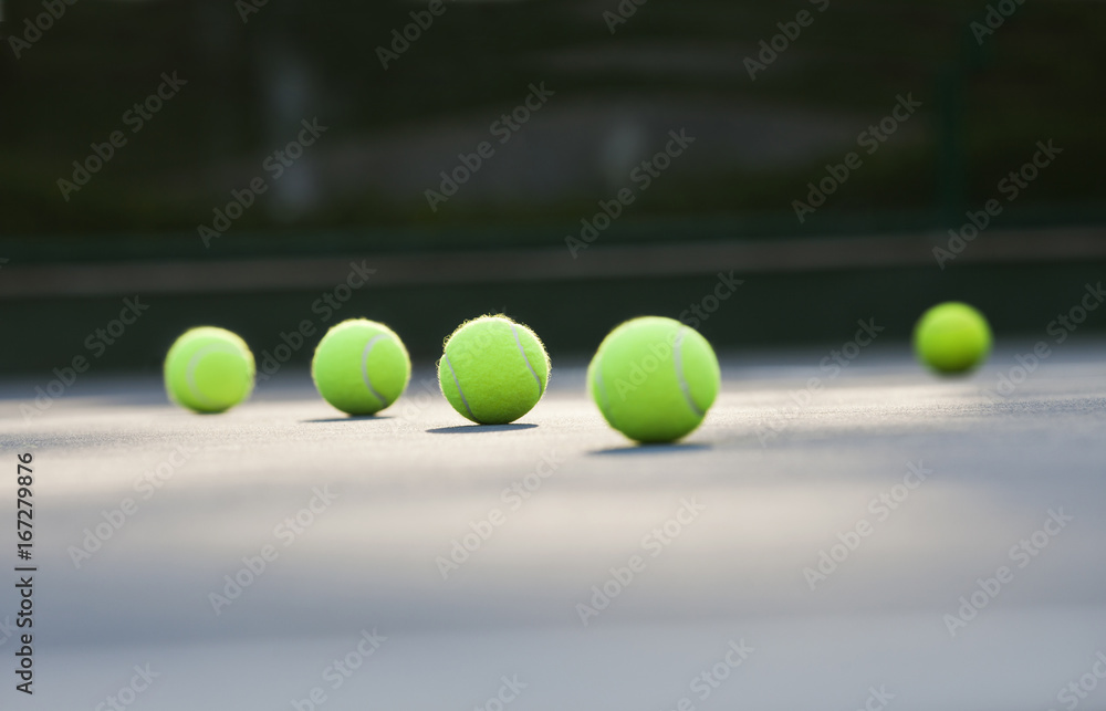 Surface level shot of tennis balls lying on ground 