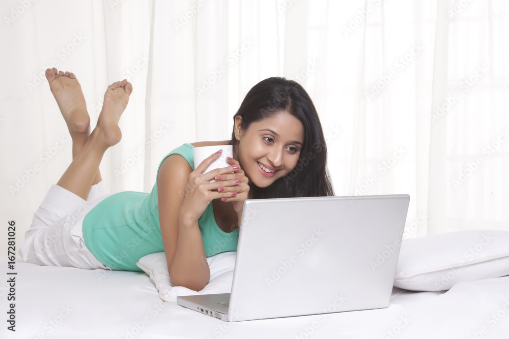 Young WOMEN using laptop while having coffee Young WOMEN using laptop while having coffee