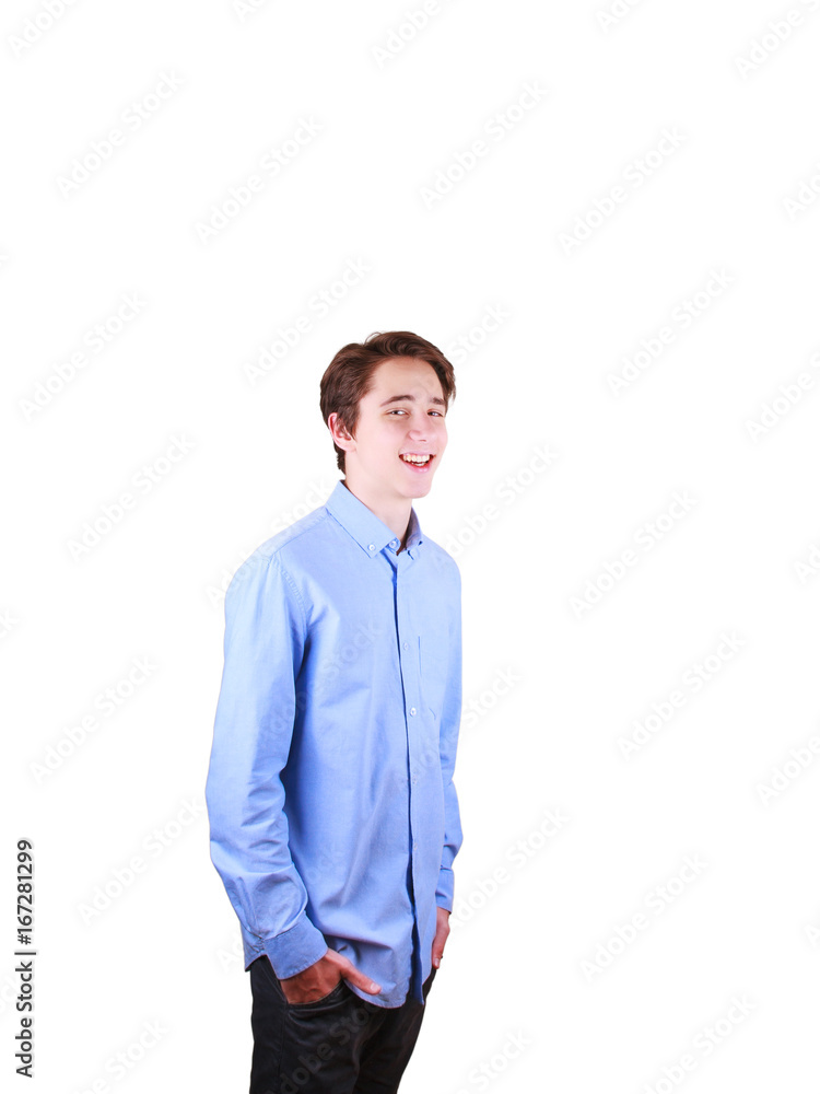 Smiling teenager. Portrait of young man in blue shirt, hands in pockets, isolated on white background Smiling teenager. Portrait of young man in blue shirt, hands in pockets, isolated on white background