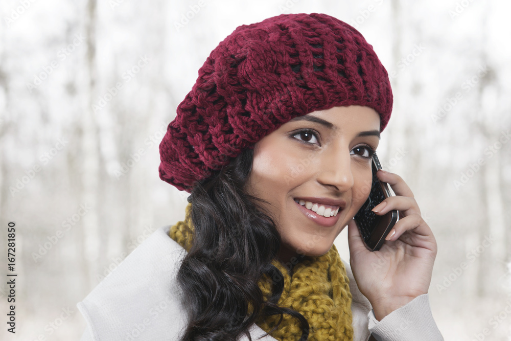 Close-up of young smiling woman having conversation on mobile phone Close-up of young smiling woman having conversation on mobile phone