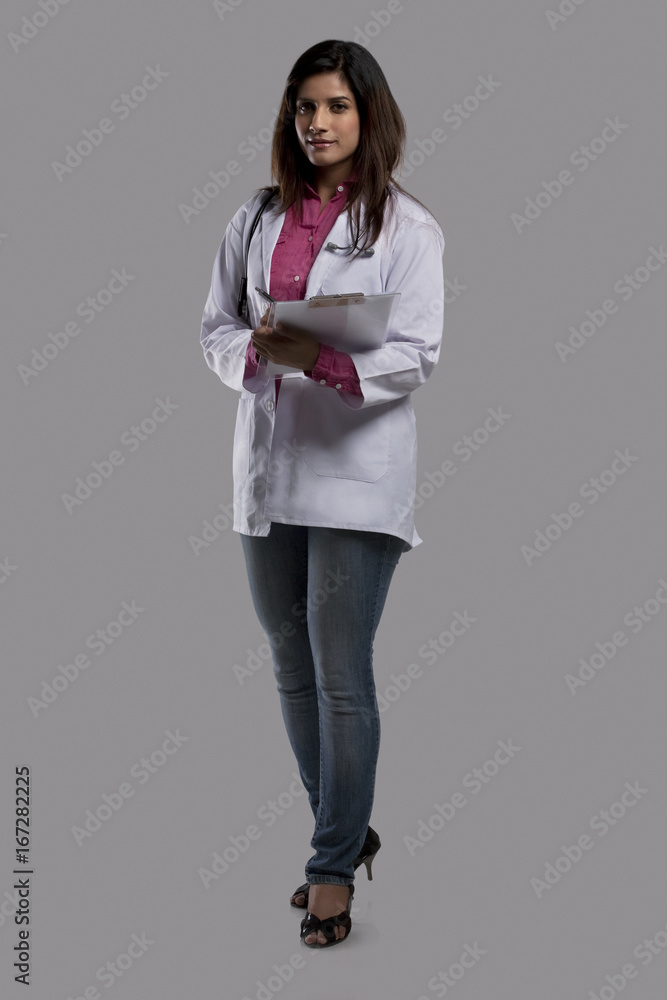 Portrait of a female doctor with a clip board Portrait of a female doctor with a clip board