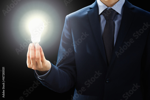 Concept, Hands of businessman holding illuminated light bulb sign.
