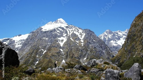 Wallpaper Mural Wide, hiker walks on rocks near scenic landscape Torontodigital.ca
