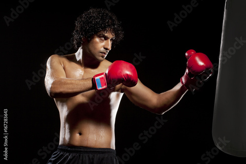 Man working out with a punching bag  © IndiaPix