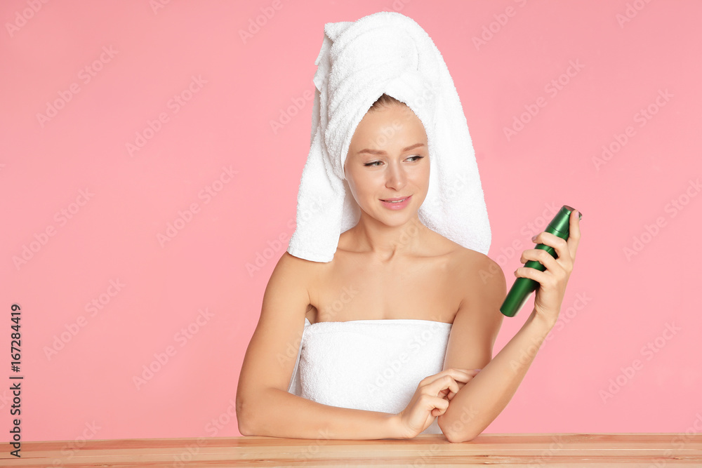 Beautiful young woman after bath with body cream on color background Beautiful young woman after bath with body cream on color background