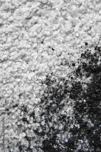 Scattered soil on white carpet, close up
