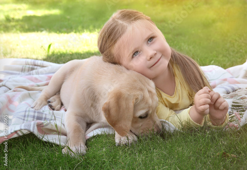 Cute child with Labrador Re...