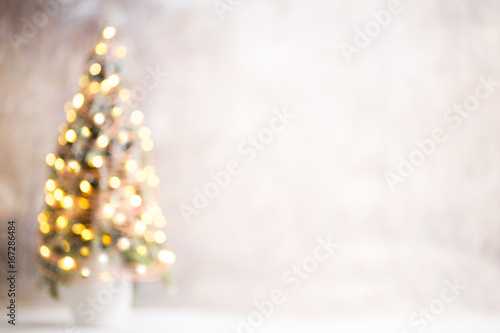 Defocused christmas tree silhouette with blurred lights.