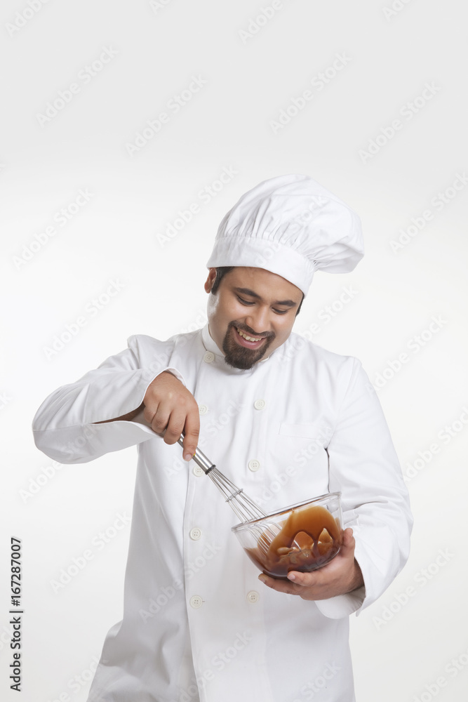 Chef mixing chocolate in a bowl Chef mixing chocolate in a bowl