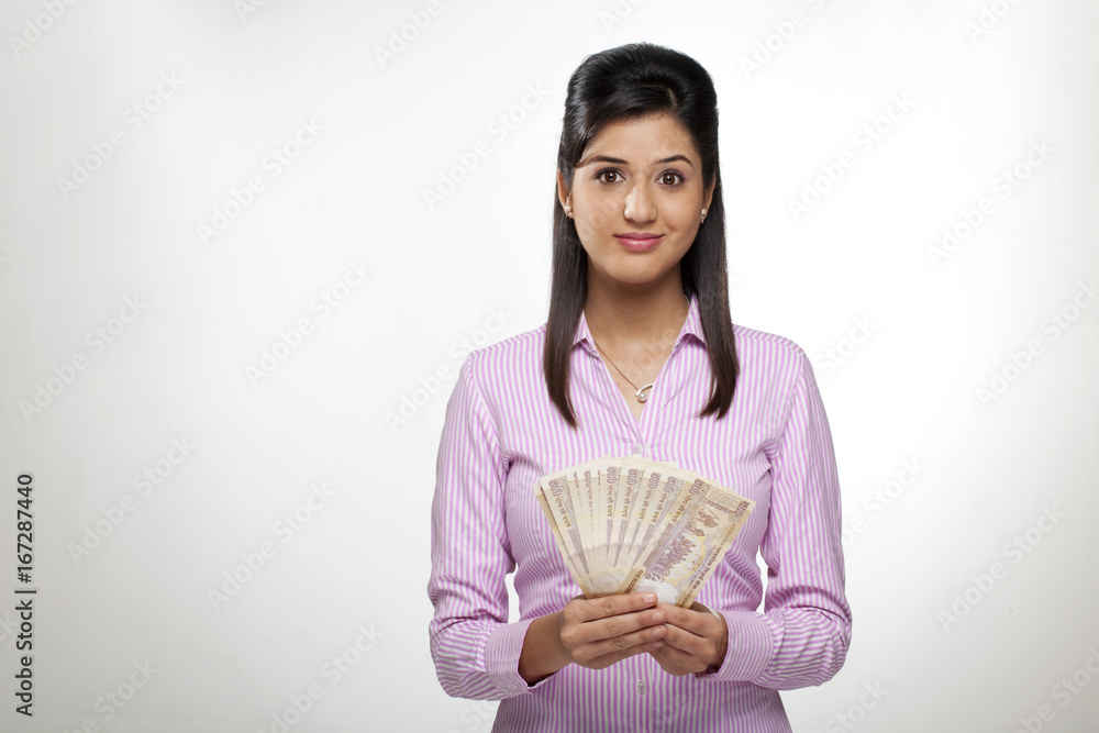 Portrait of a female executive with currency Portrait of a female executive with currency