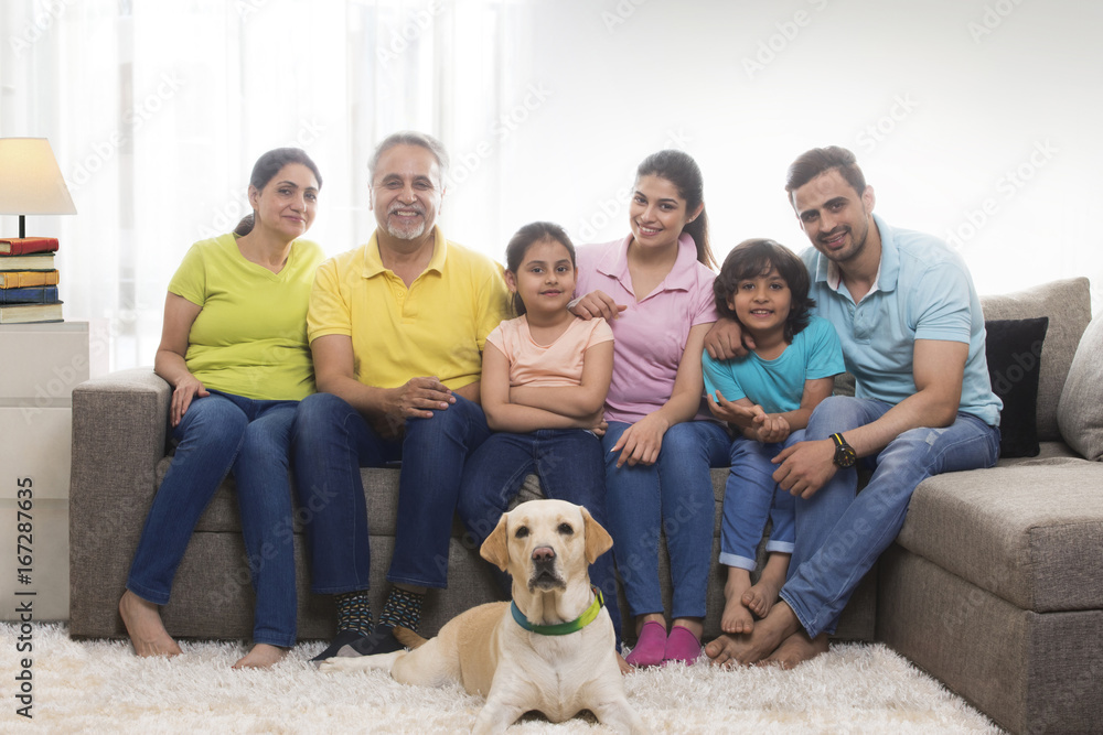 Portrait of three generation family in living room with dog Portrait of three generation family in living room with dog