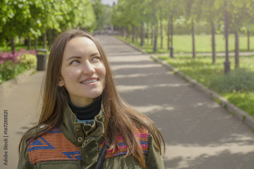 Portrait of a smiling young woman in the summer Park in the sun Portrait of a smiling young woman in the summer Park in the sun