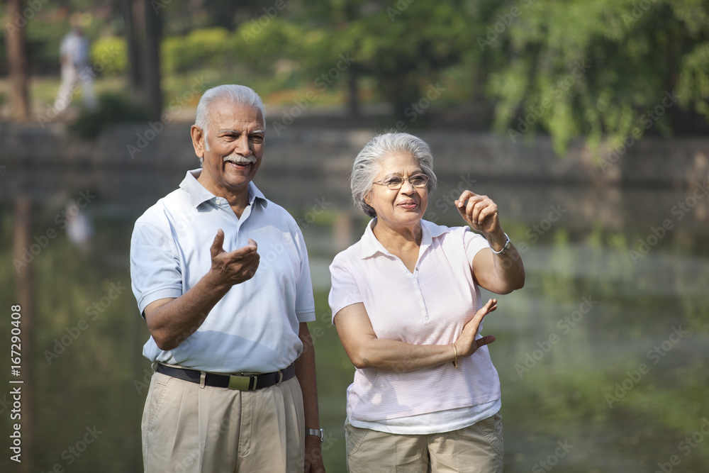 Happy couple smiling while enjoying at park Happy couple smiling while enjoying at park