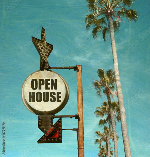aged and worn vintage photo of open house sign with palm trees