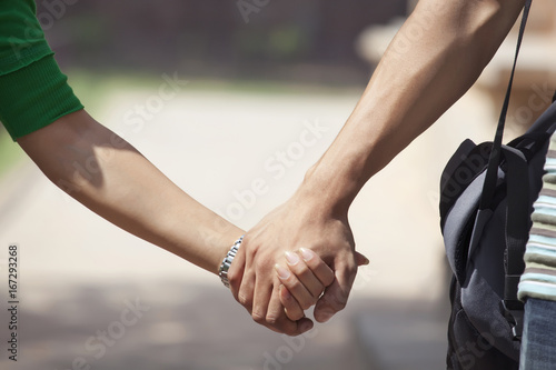 Couple holding hands in a park