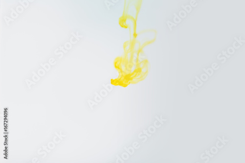 Yellow ink in water, artistic shot, abstract background