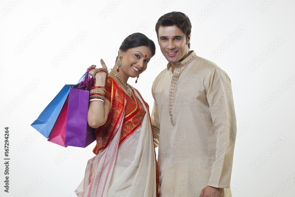 Portrait of a Bengali couple with shopping bags Portrait of a Bengali couple with shopping bags