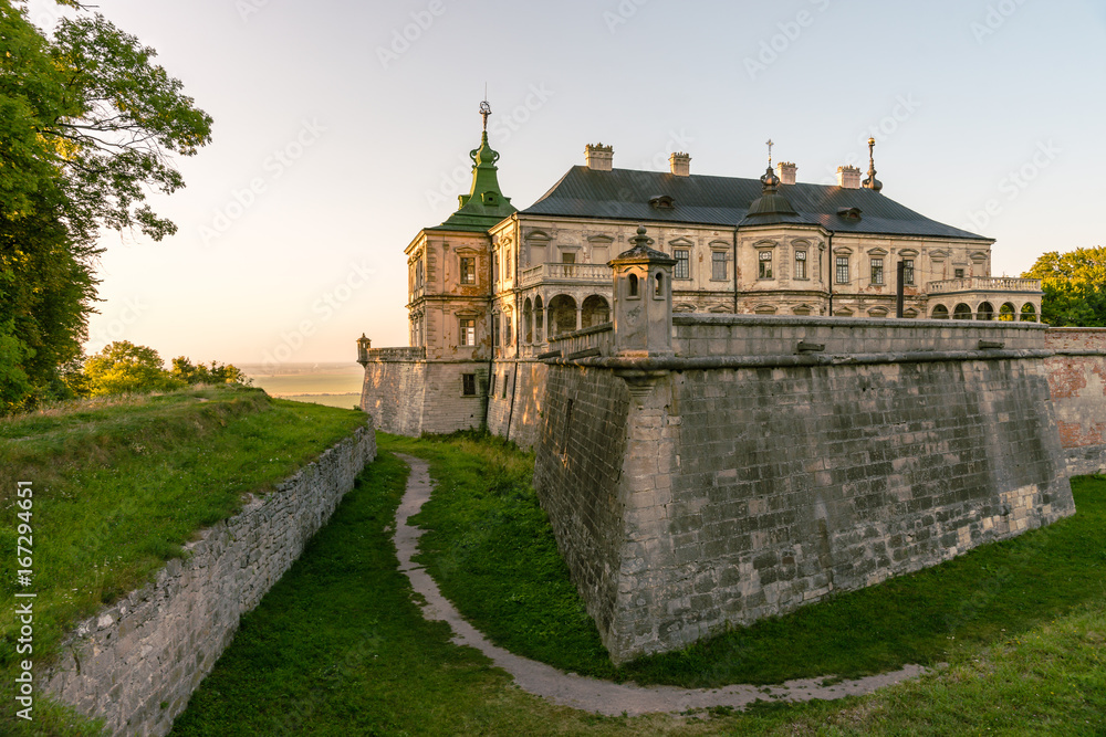 Medieval Pidhirtsi Castle in sunset summer light, Pidhirtsi village, Lviv region, Ukraine