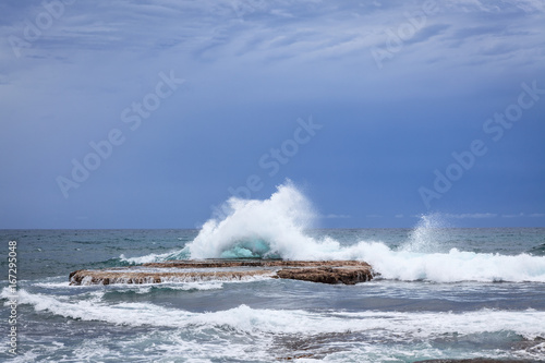 Waves crashing on rock