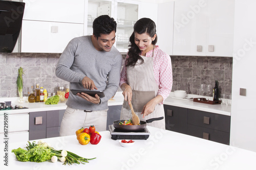 Man giving cooking tips from digital tablet