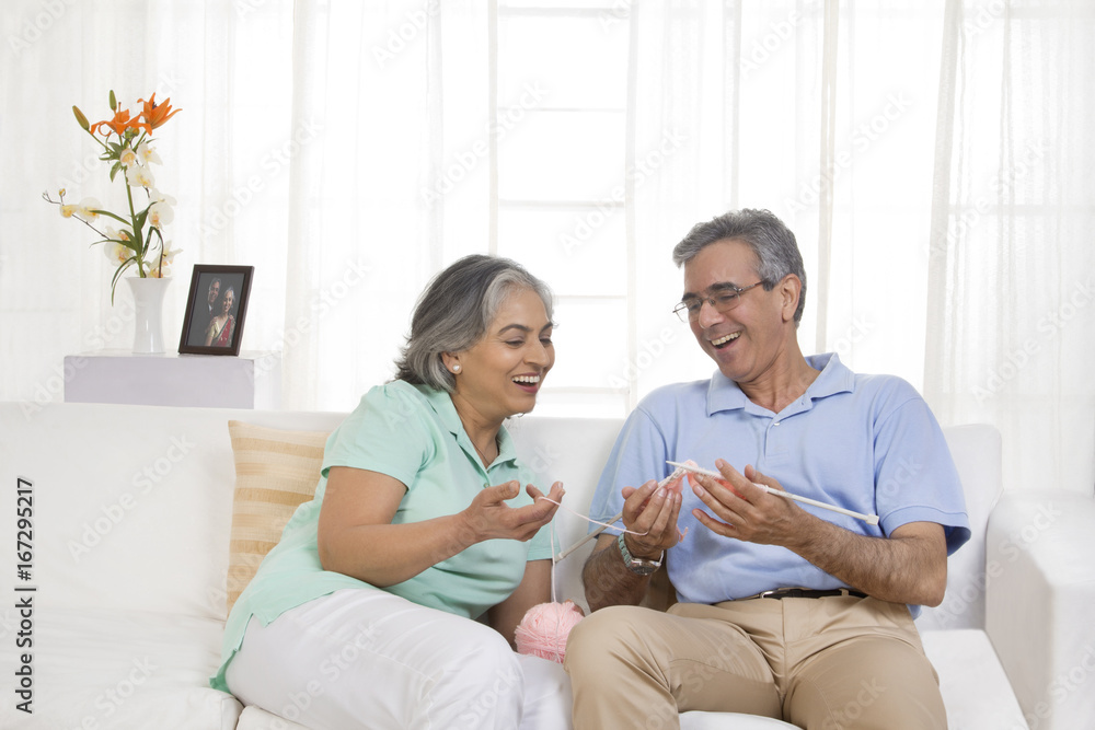 Fototapeta premium Wife teaching her husband knitting