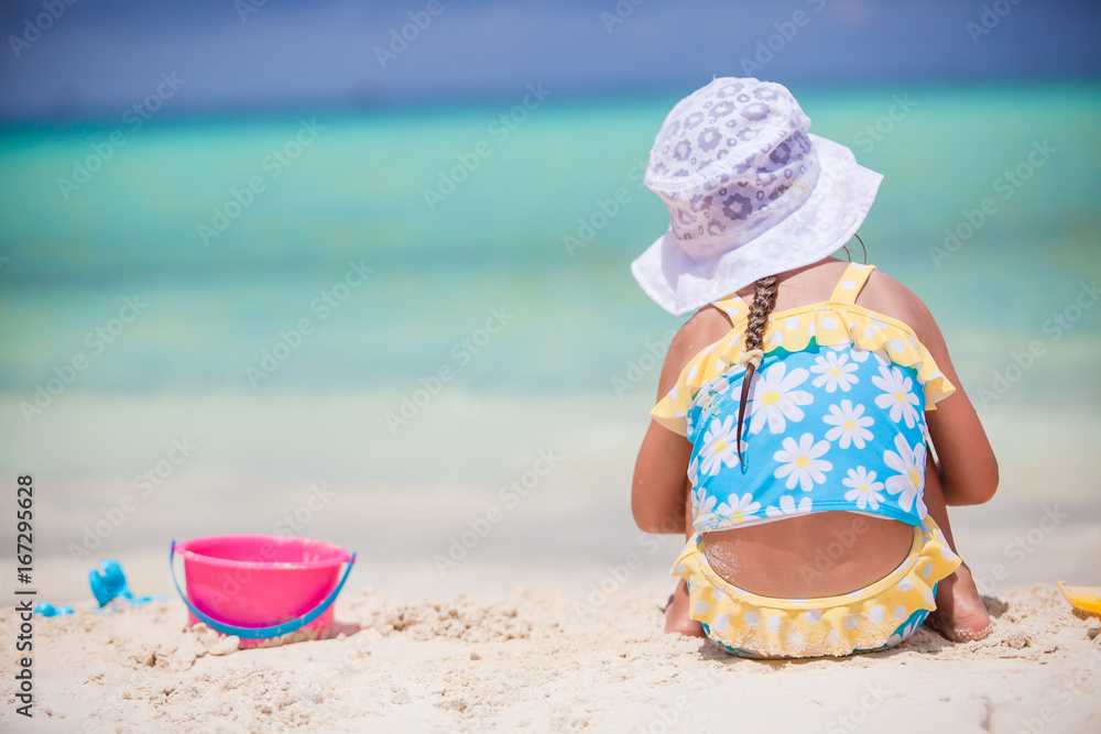 Little girl play with beach toys during tropical vacation Little girl play with beach toys during tropical vacation
