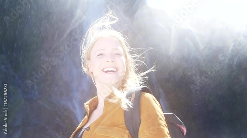Blonde woman backpacker, Milford Sound waterfall slow motion