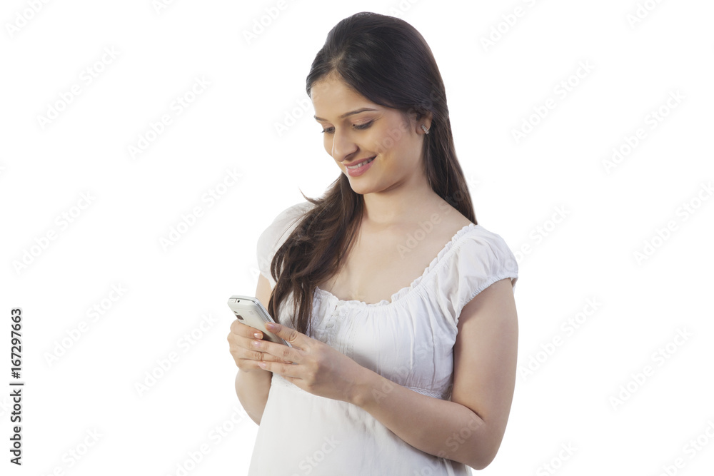 Pregnant woman using her mobile phone Pregnant woman using her mobile phone