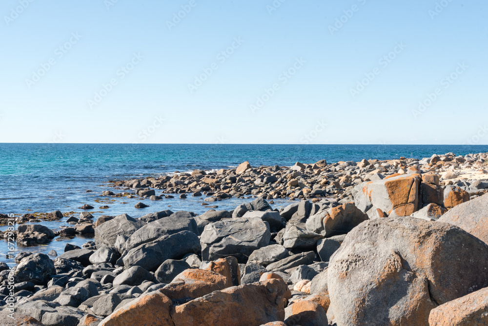 Blue sky, ocean and rock formations - coastline on a sunny winter's day at Bingi, near Moruya in NSW, Australia. Nature background. Blue sky, ocean and rock formations - coastline on a sunny winter's day at Bingi, near Moruya in NSW, Australia. Nature background.