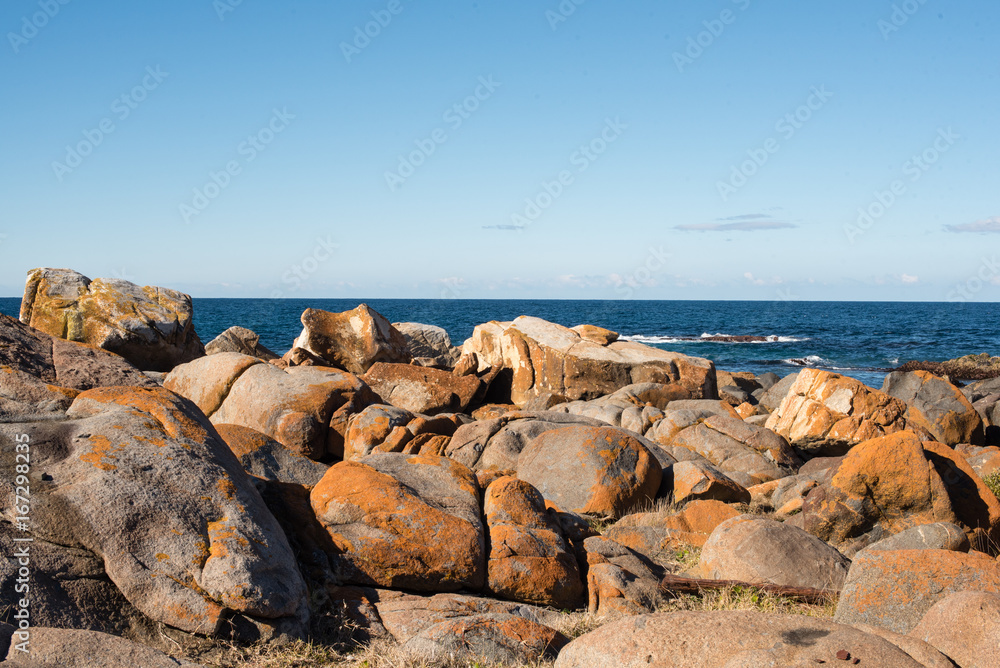 Blue sky, ocean and rock formations - coastline on a sunny winter's day at Bingi, near Moruya in NSW, Australia. Nature background.