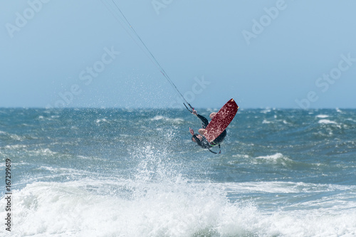 Kiteboarder enjoy surfing on a sunny day. photo