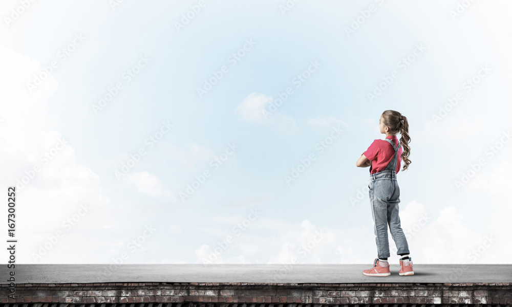 Concept of careless happy childhood with girl looking far away Concept of careless happy childhood with girl looking far away