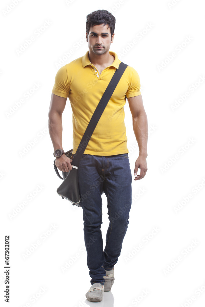 Portrait of young man walking over white background Portrait of young man walking over white background