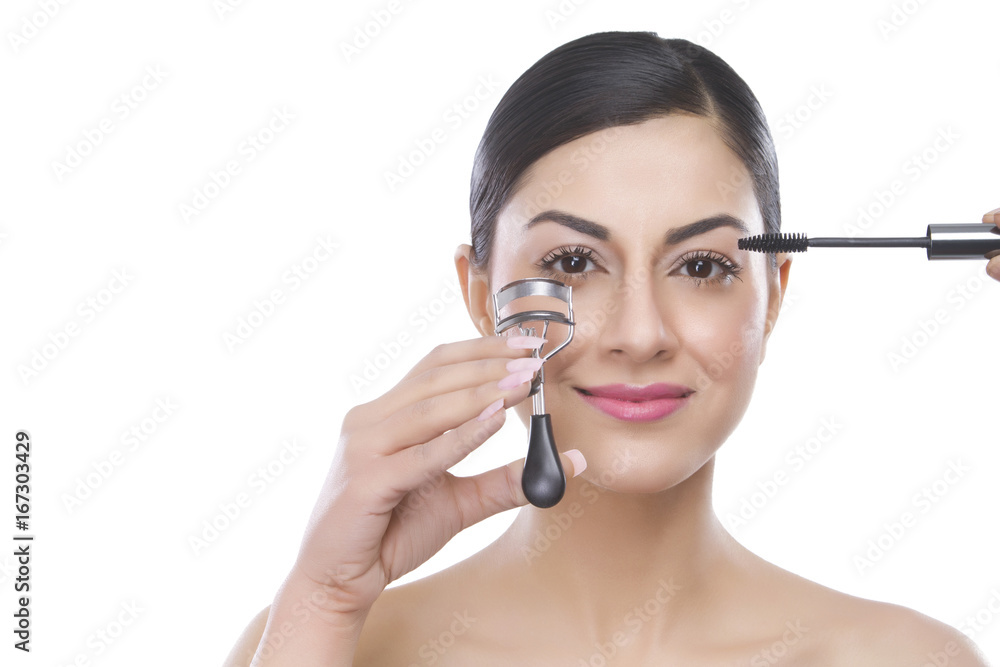 Portrait of a beautiful woman applying mascara Portrait of a beautiful woman applying mascara