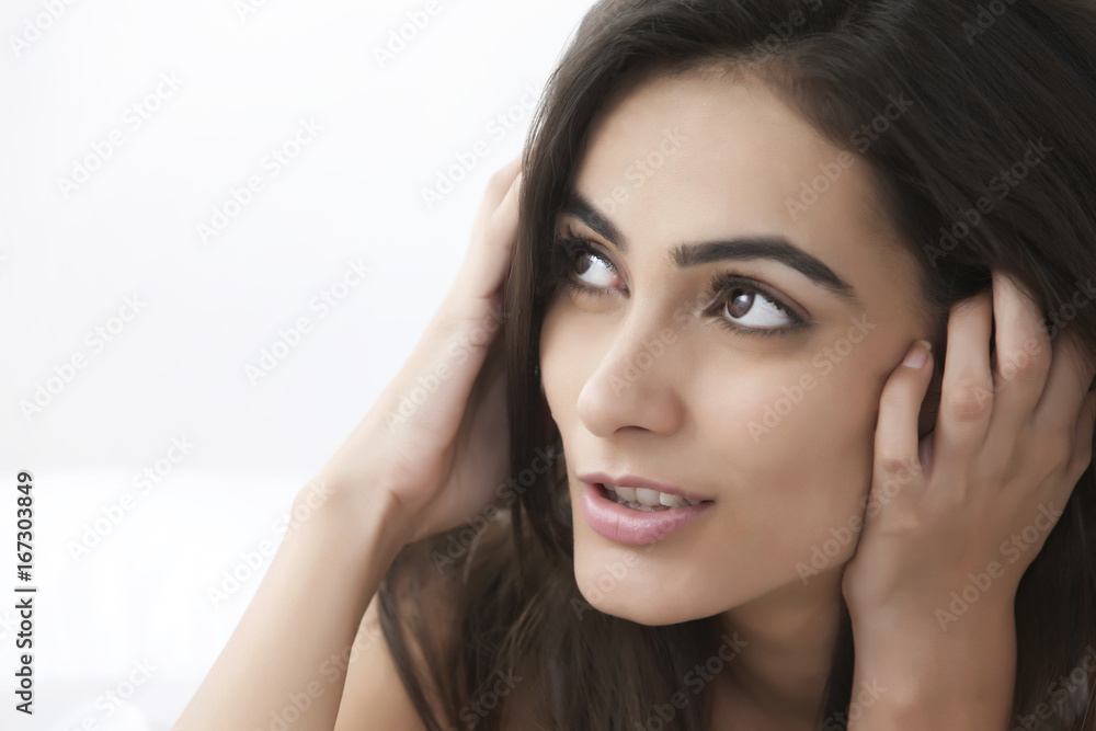 Close-up of thoughtful young woman looking at copy space Close-up of thoughtful young woman looking at copy space