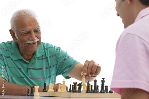 Grandfather and grandson playing chess