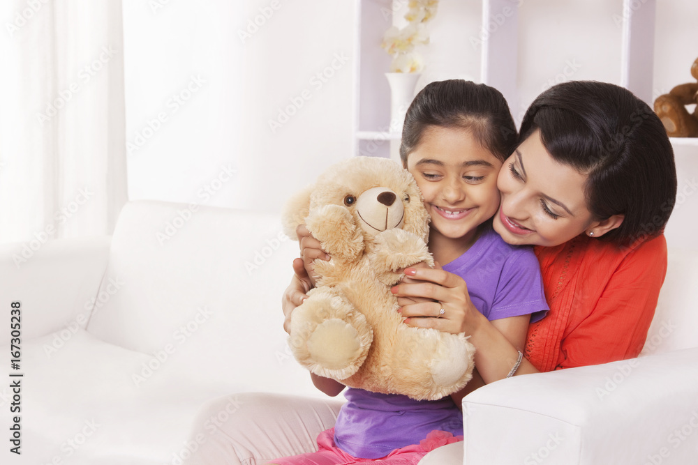 Mother and daughter playing with stuffed toy Mother and daughter playing with stuffed toy