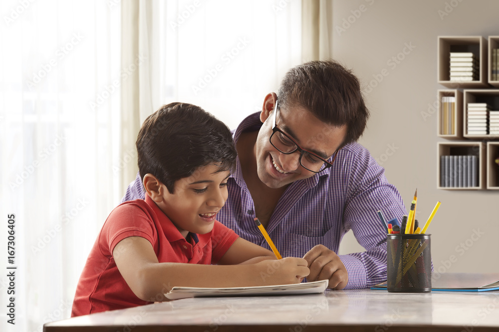 Father helping son with homework 