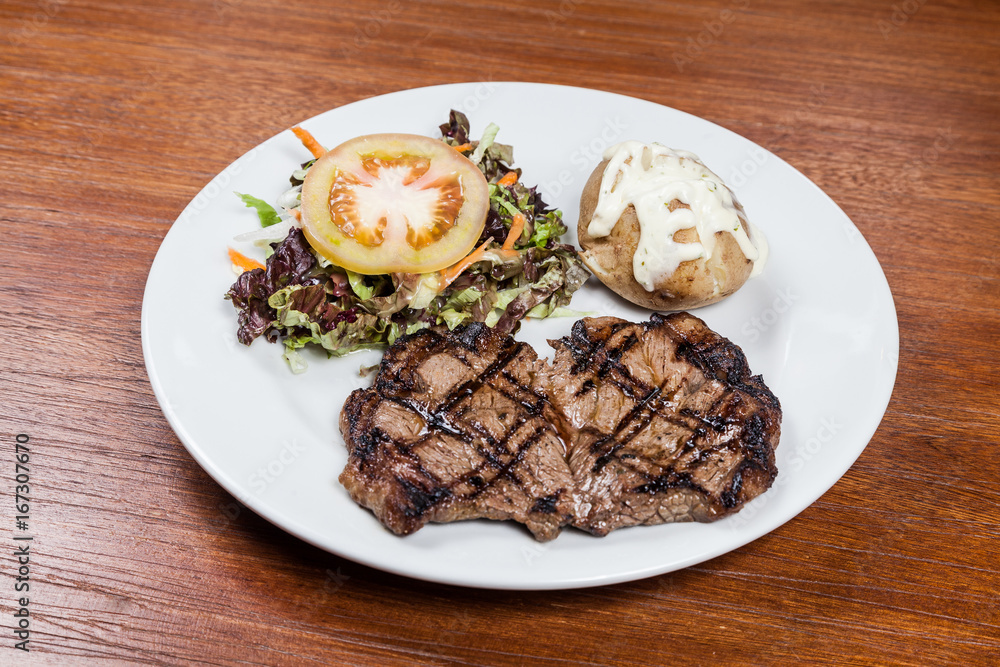 Roast beef steak with potato and salad