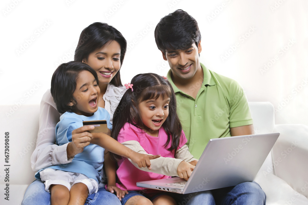 Family with laptop and credit card Family with laptop and credit card