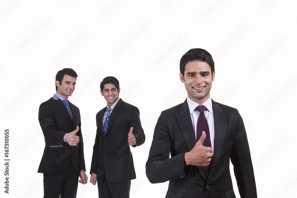Portrait of businessmen giving thumbs up Portrait of businessmen giving thumbs up
