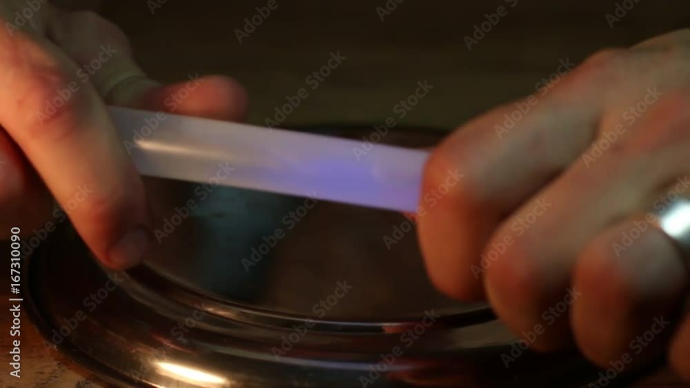 Hands light up glowstick on display, close up Hands light up glowstick on display, close up