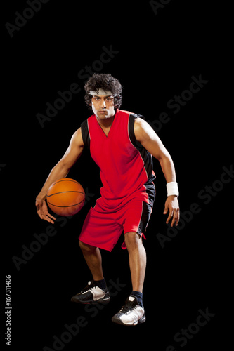 Man playing basket ball over white background 