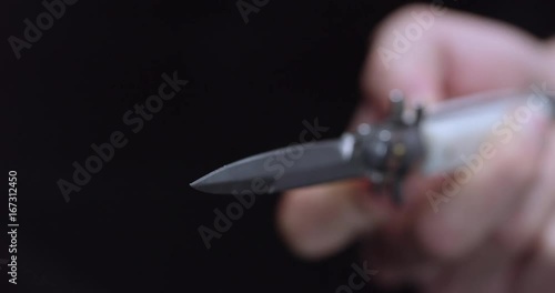 Close up, person opens switchblade