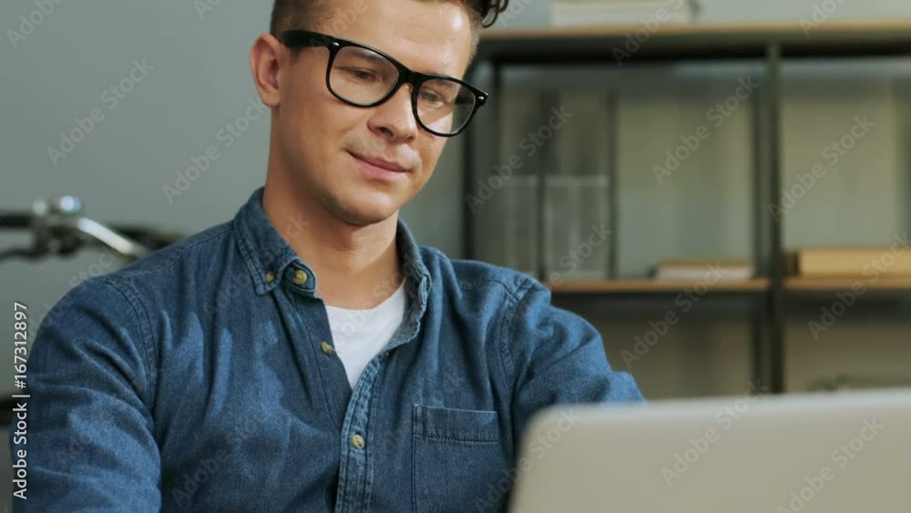 Portrait of happy young business man in the glasses finish working in the modern office. Portrait of happy young business man in the glasses finish working in the modern office.