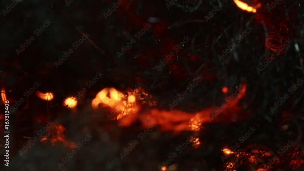 Close up, sparks travel through steel wool Close up, sparks travel through steel wool