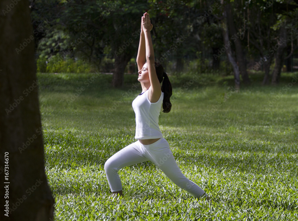Young woman doing yoga with hands outstretched Young woman doing yoga with hands outstretched