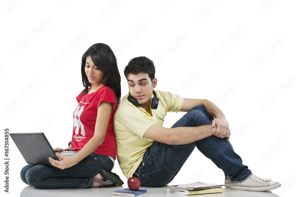 Young adult couple with laptop 