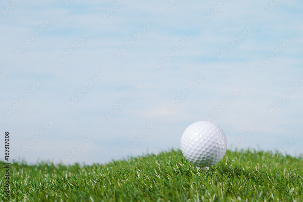 golf ball stands on a tee against the sky golf ball stands on a tee against the sky